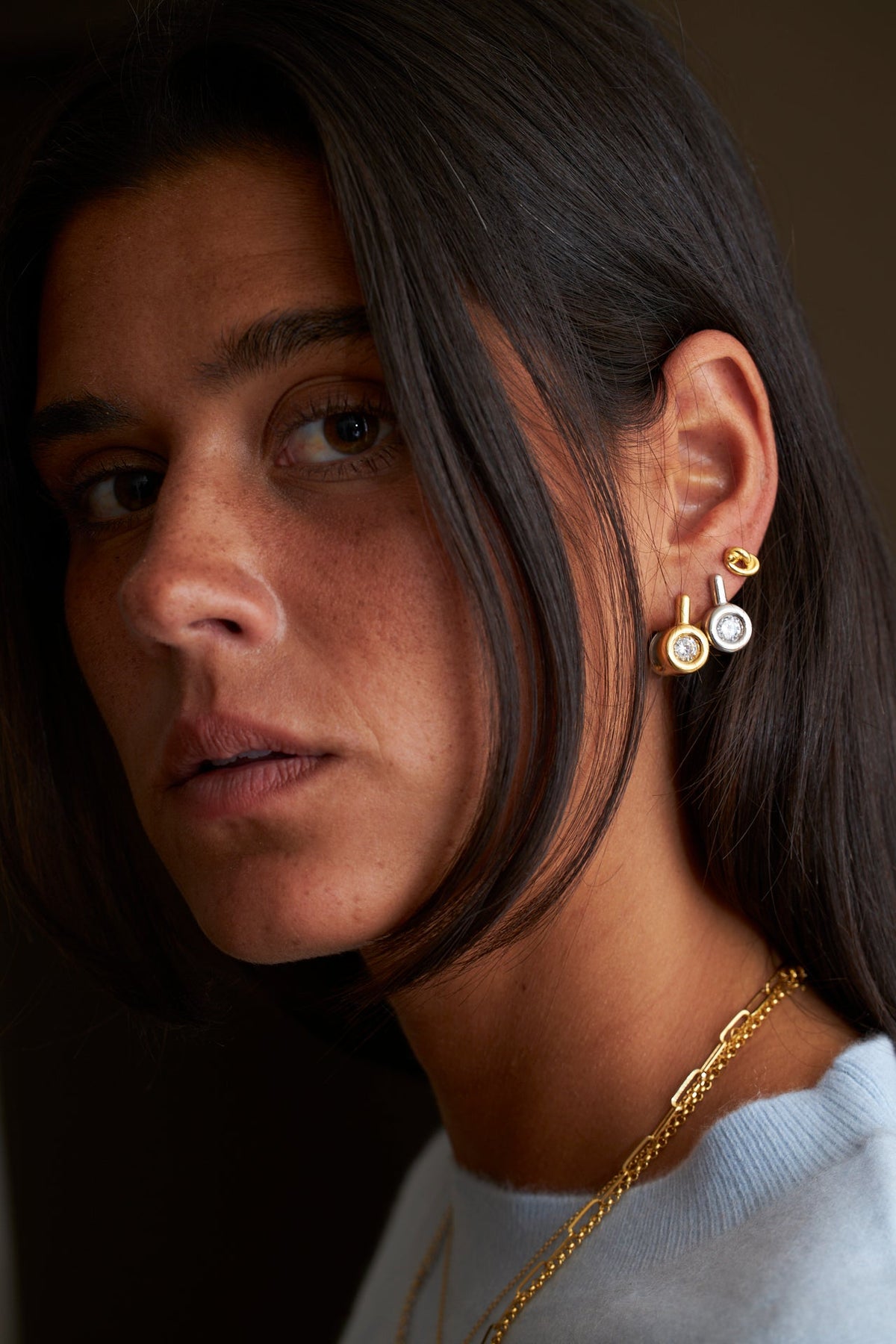 Close-up of a woman showcasing elegant earrings and personalized jewelry gifting tips.
