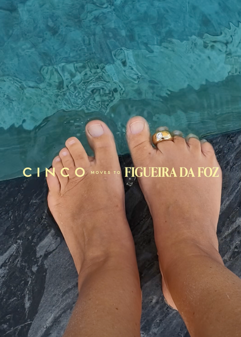 A top-down view of a person's feet resting on a dark stone surface next to turquoise water, with a gold ring on one toe. Gold text across the center reads 'CINCO MOVES TO FIGUEIRA DA FOZ'.