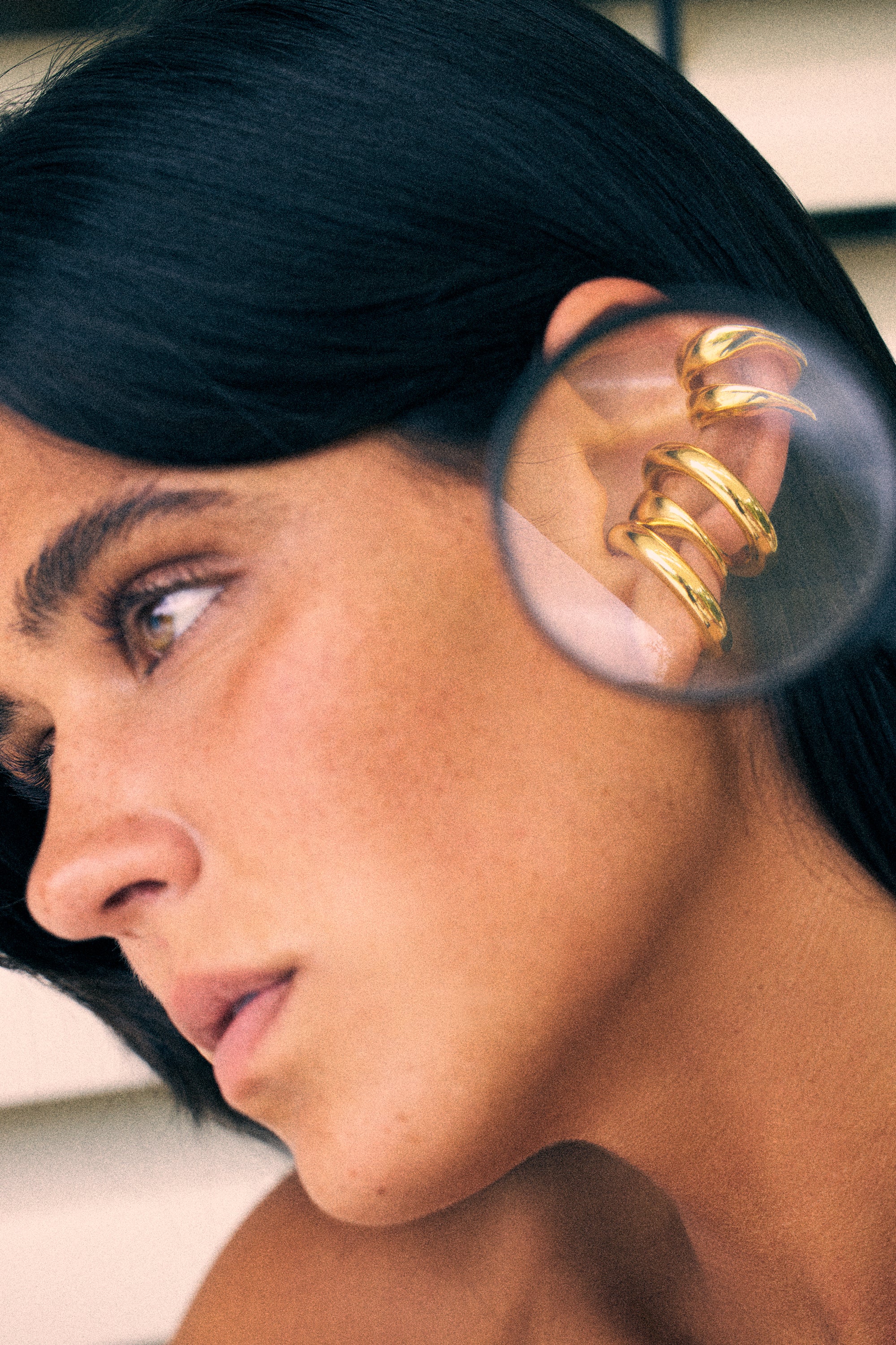 model wearing charli earcuff and bella earcuff in gold