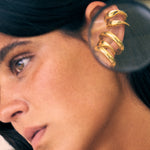 model wearing bella earcuff and charli earcuff in gold