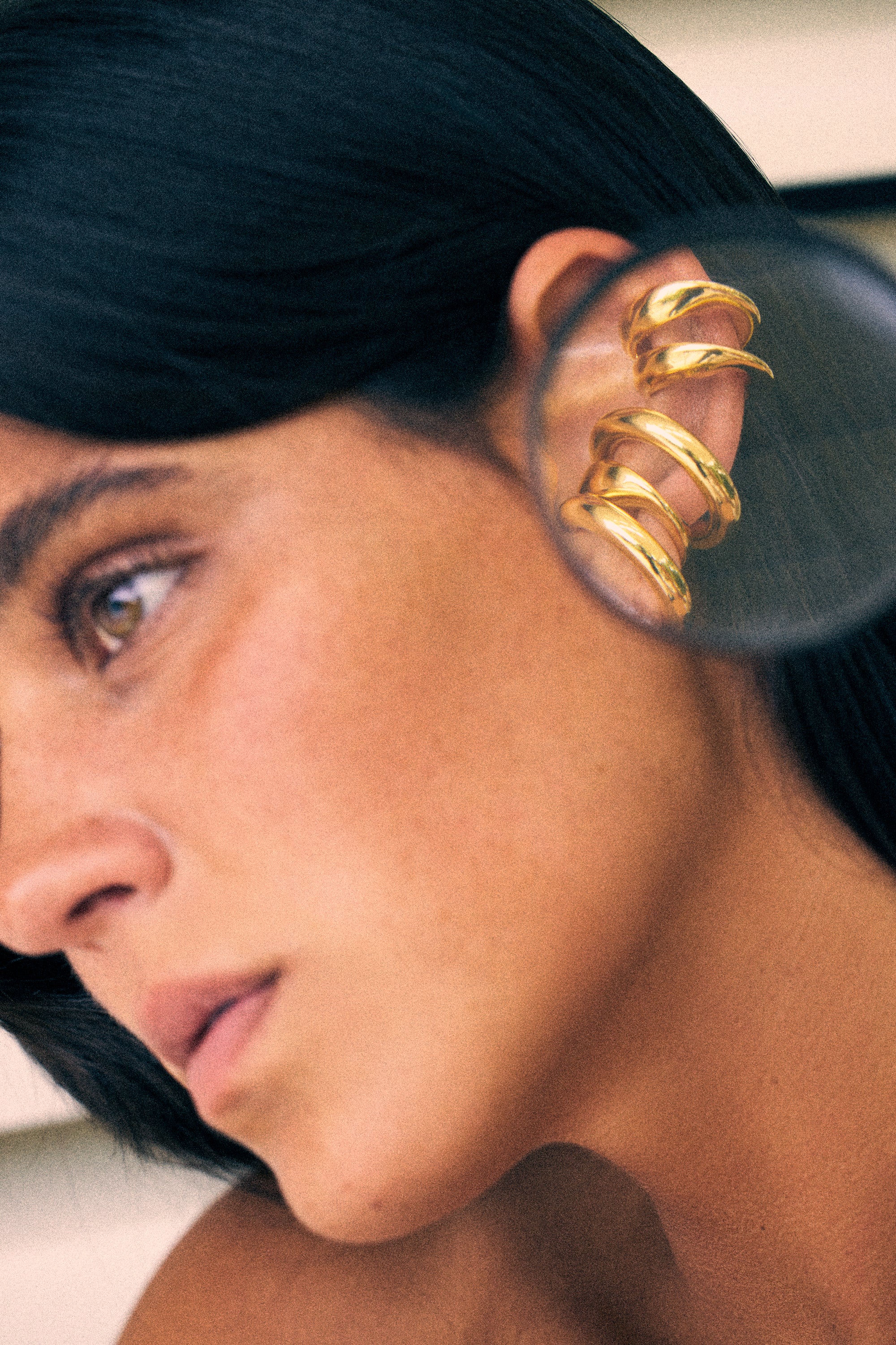 model wearing bella earcuff and charli earcuff in gold