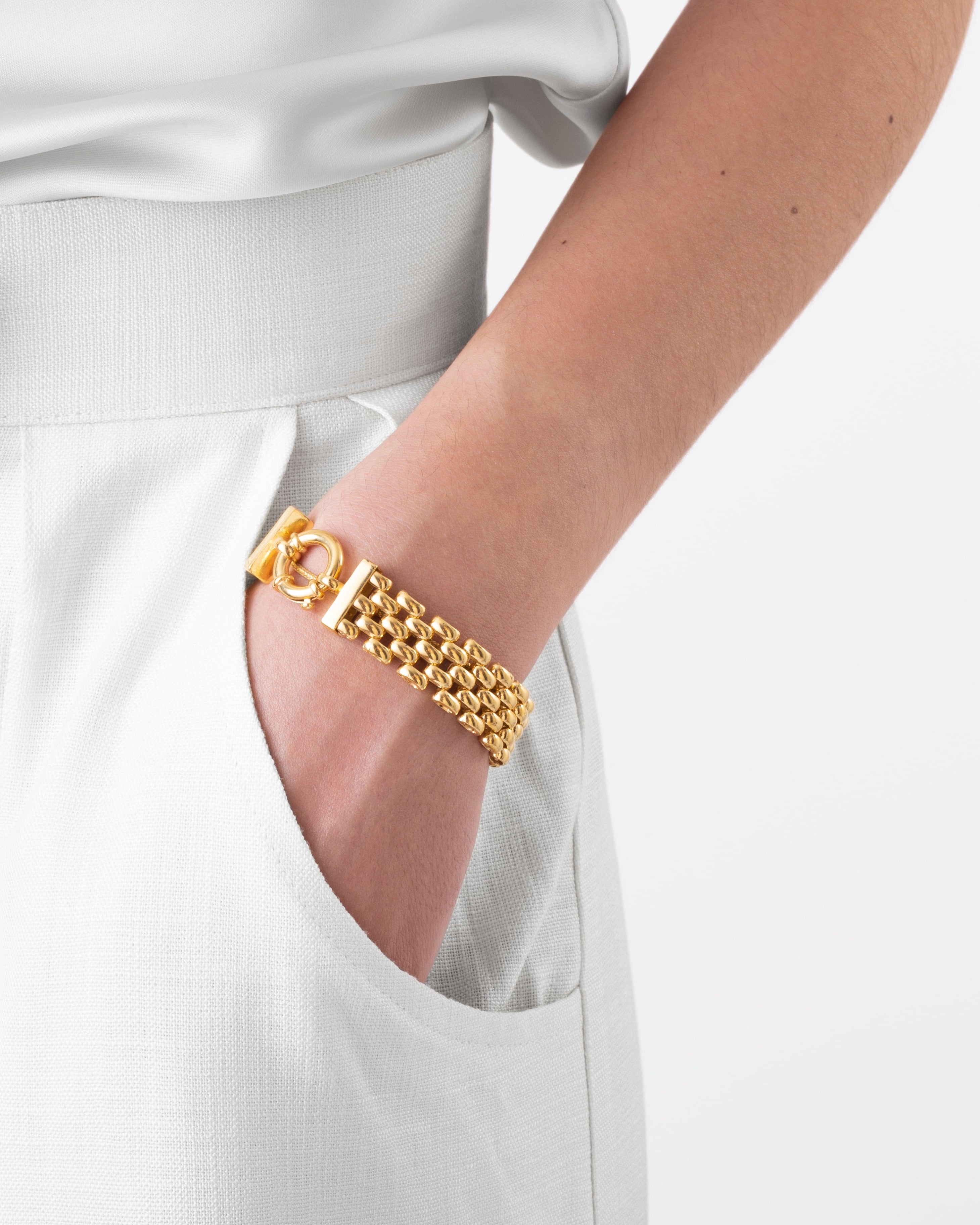 Gold bracelet on a white outfit