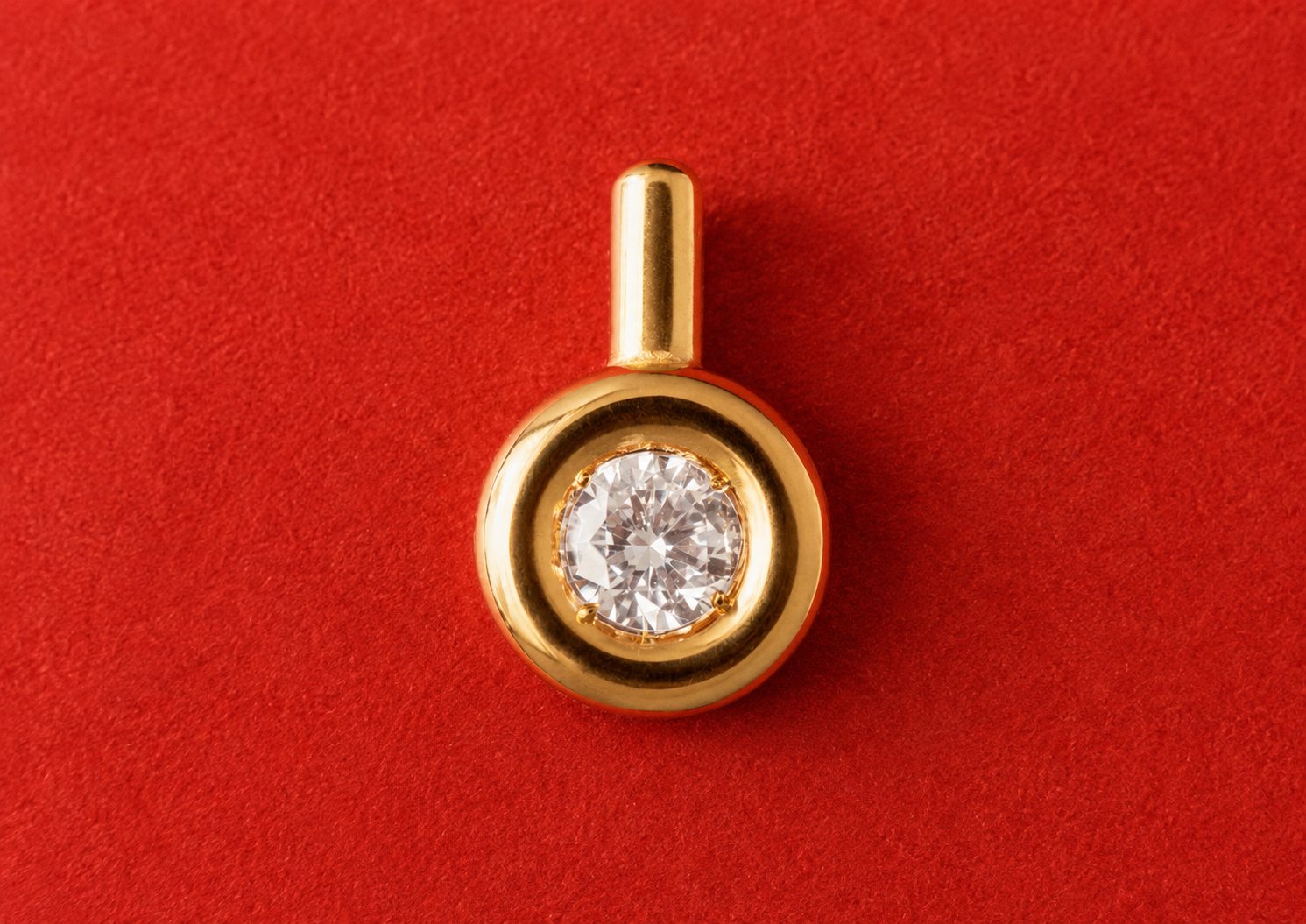 Gold pendant on red velvet background