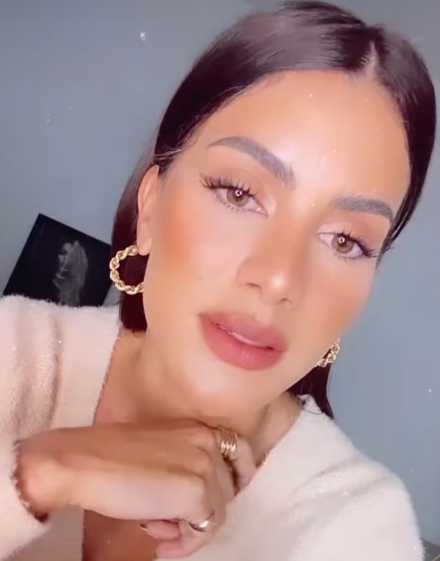 CINCO hoop earrings worn on model, showcasing elegant gold detail and facial features.