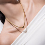 model wearing alphabet necklace with pendant M in gold