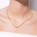 model wearing alphabet necklace with pendant S in gold