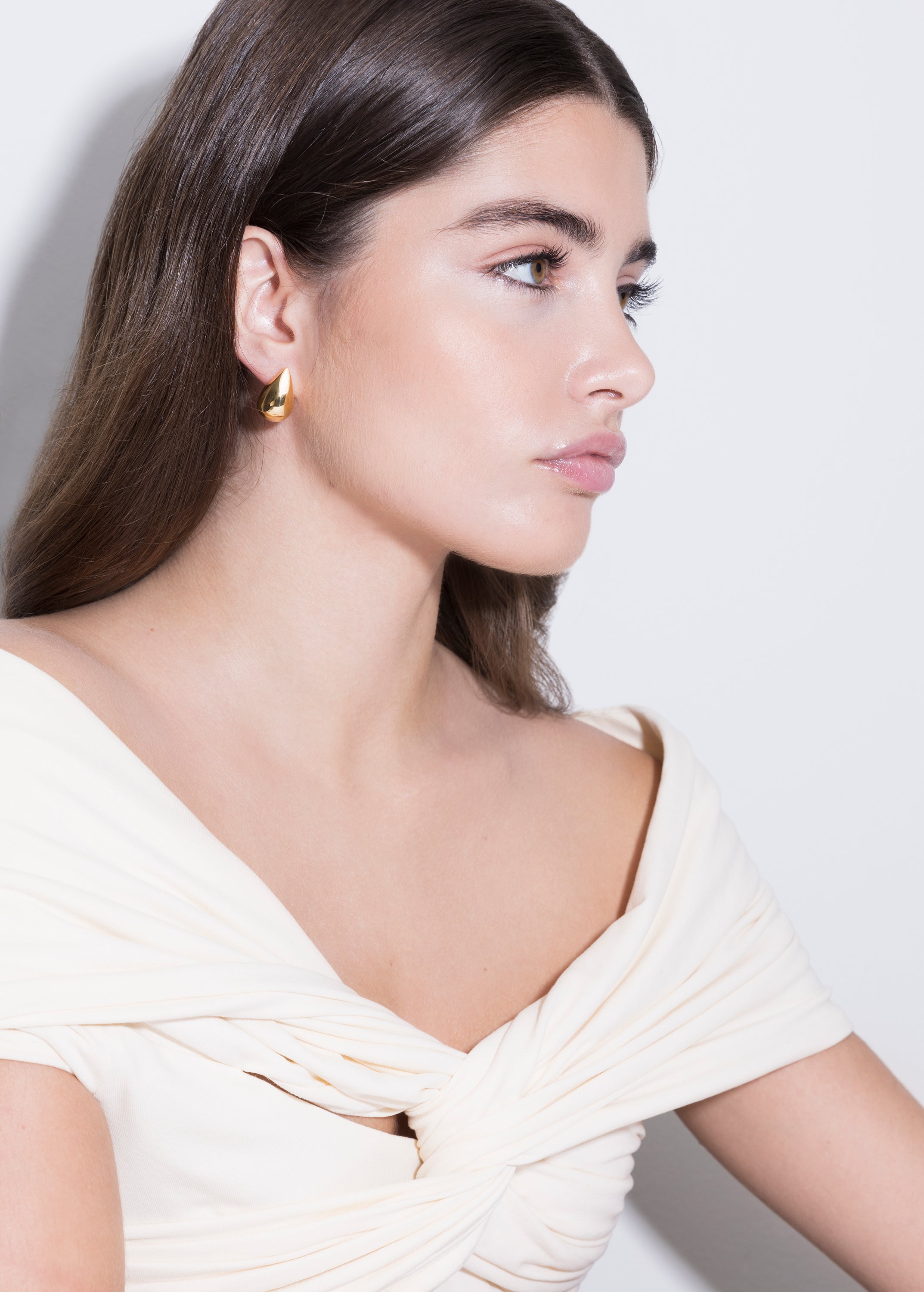 model wearing constantin earrings in gold