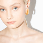 model wearing fiona earrings in gold