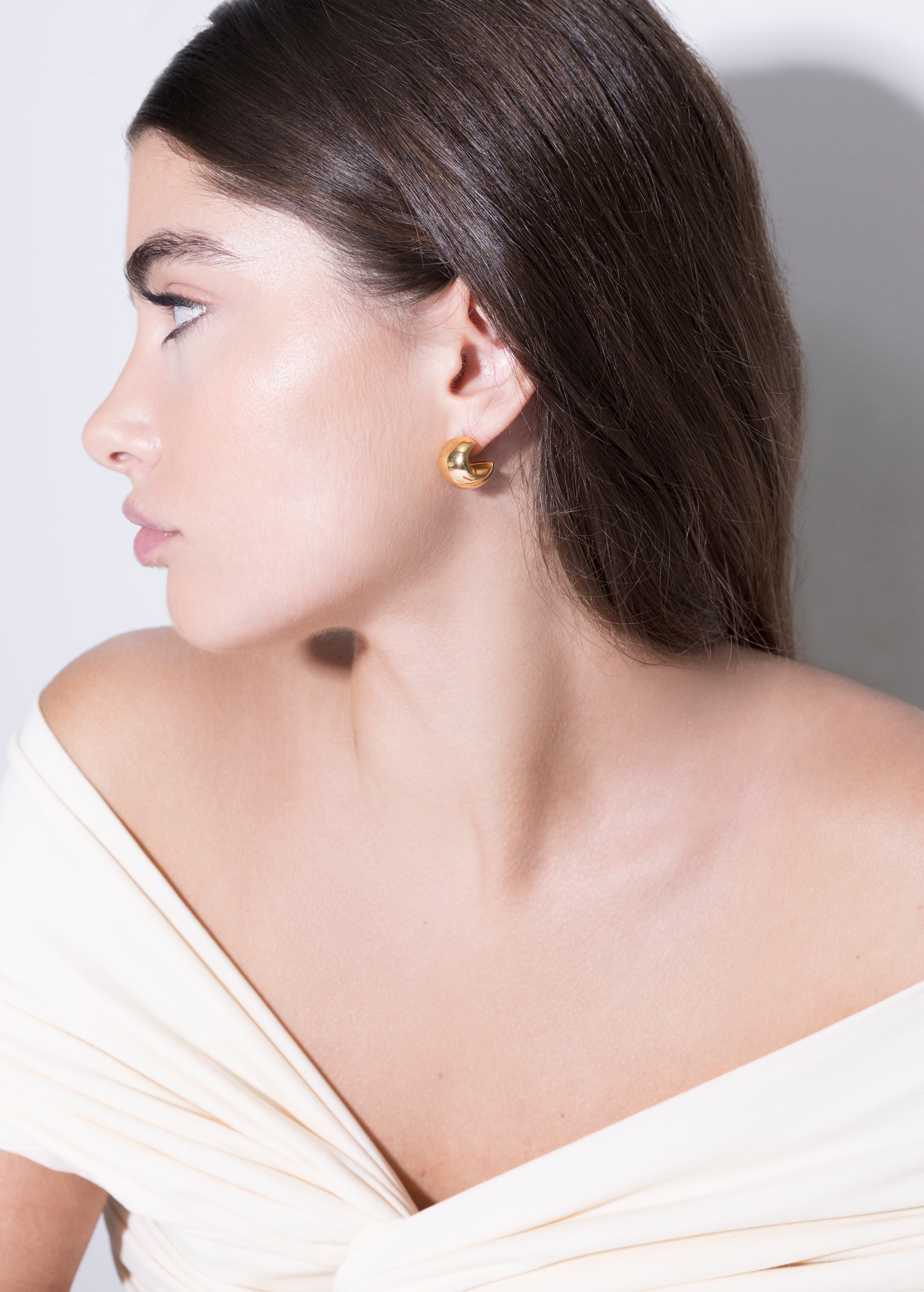 model wearing gina earrings in gold