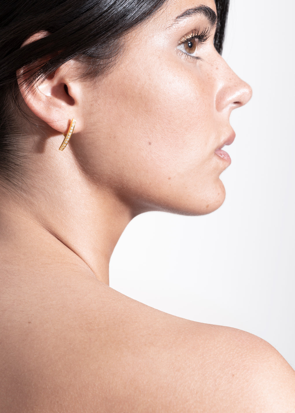 model wearing laura earrings in gold