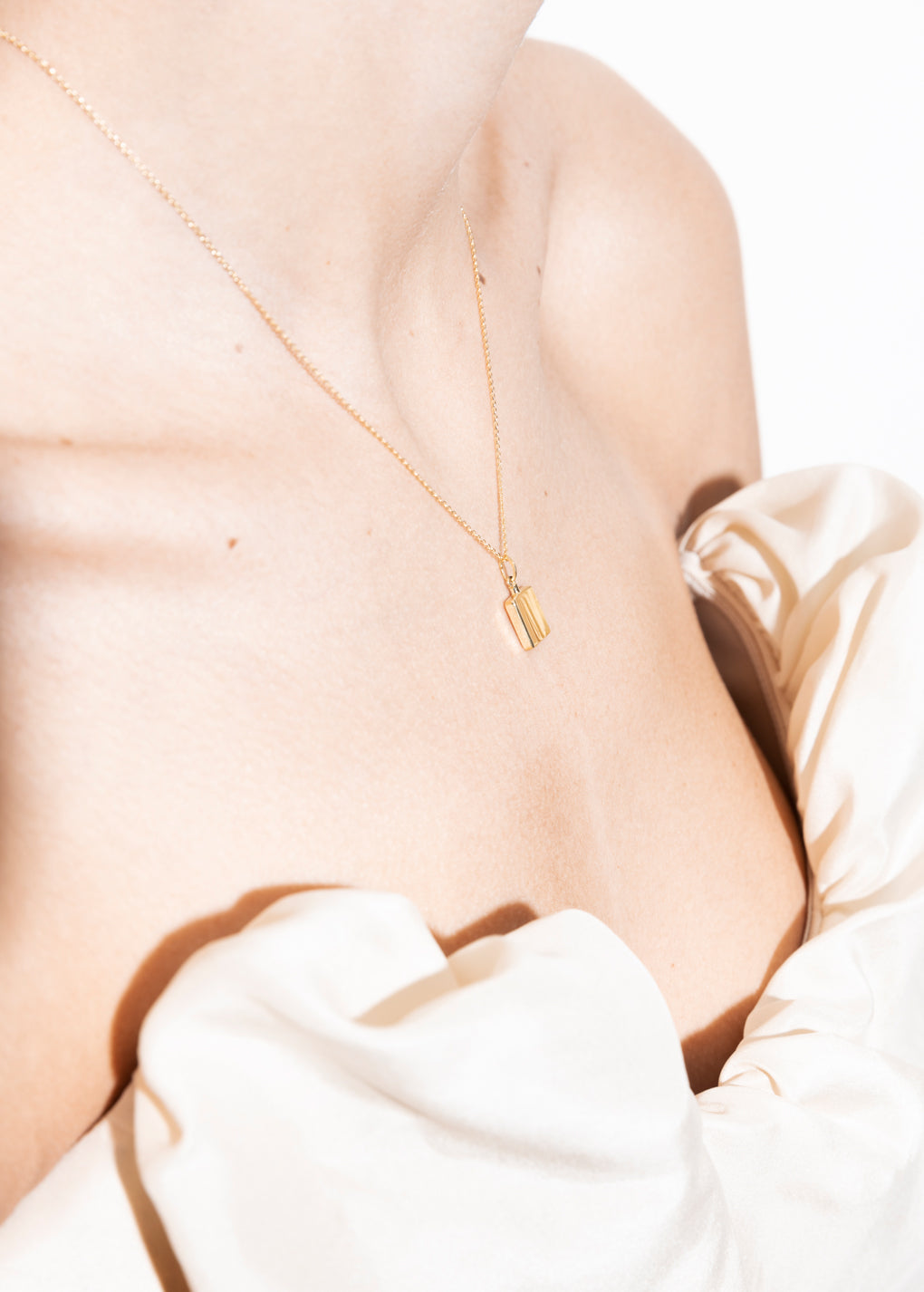 model wearing miles necklace 18k 