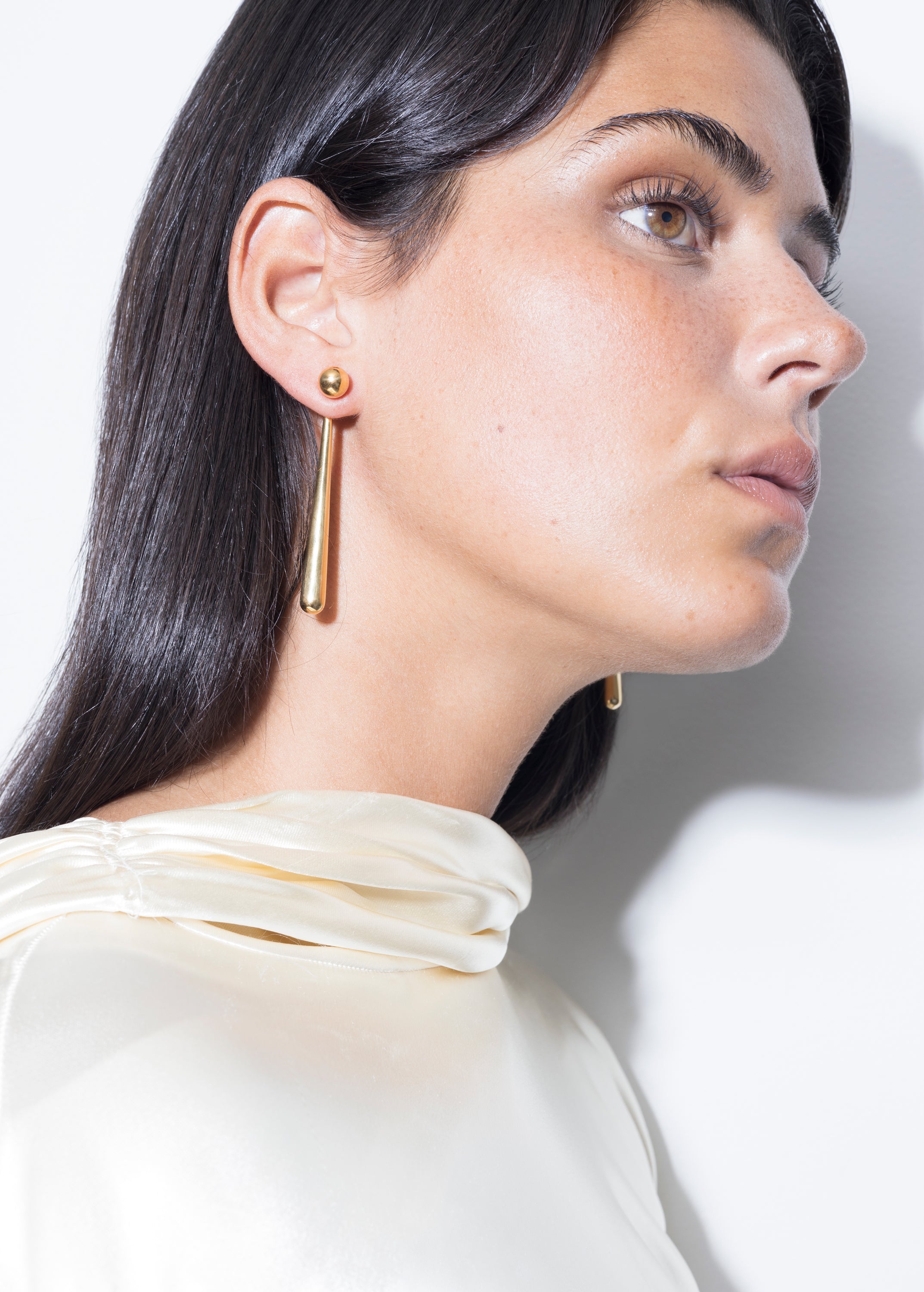 model wearing sade earrings in gold