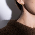 model wearing tilly earrings in gold
