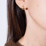 model wearing tilly earrings in gold