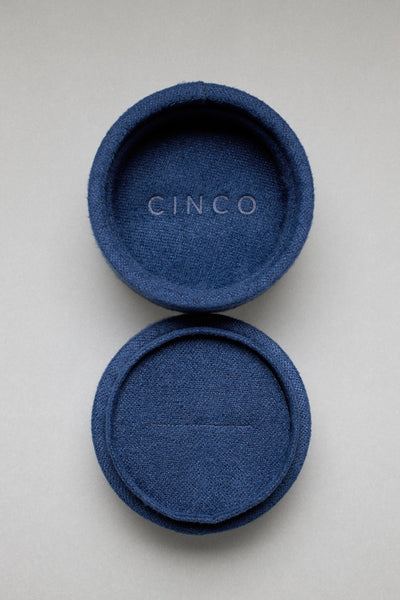 Tiny velvet jewelry box in navy blue, showcasing elegant design for memorable gift presentations.